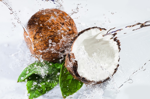 Cracked coconut with leafs