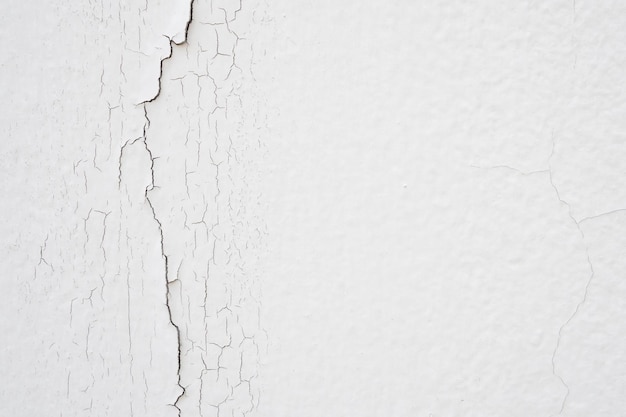 Cracked concrete on white wall texture background