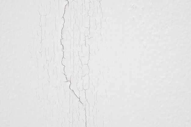 Cracked concrete on white wall texture background