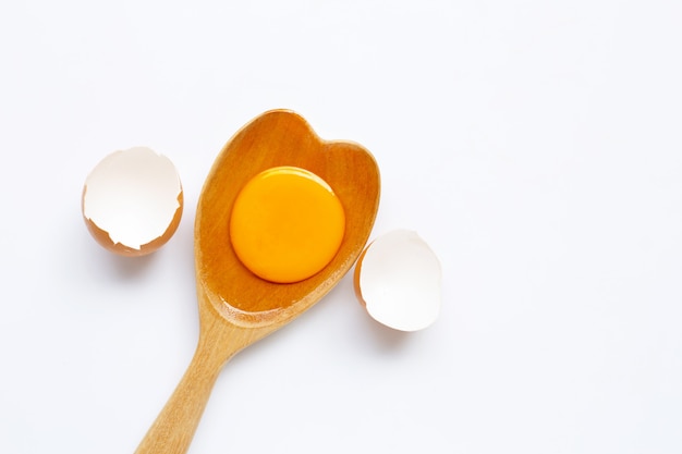 Cracked egg on wooden spoon