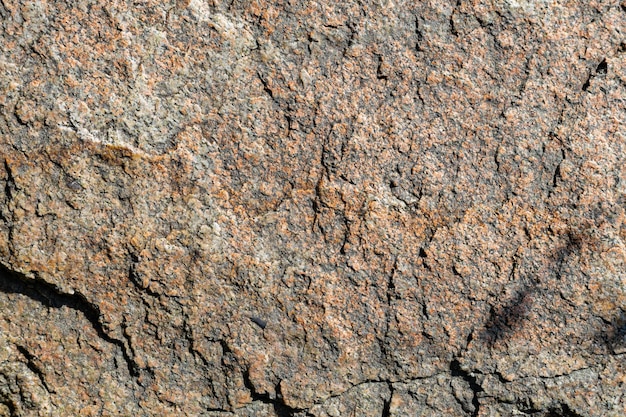 Cracked granite stone texture. Granite rock surface. Natural stone backdrop. Copy space