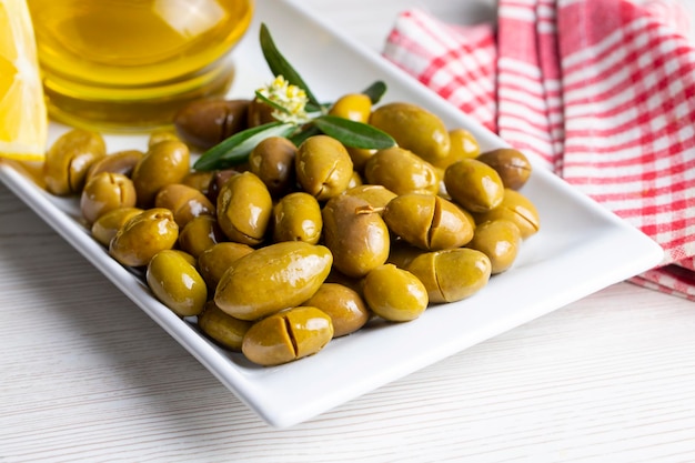 Cracked green olives. Cracked green olives with lemon. Turkish style olive (Turkish name; kirma zeytin)