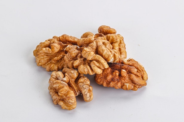 Cracked kernel brown walnut heap isolated