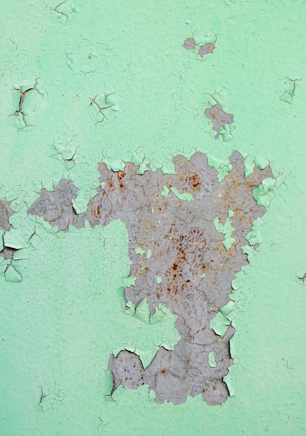 Cracked and peeling of green color paint on steel with rusted texture and background