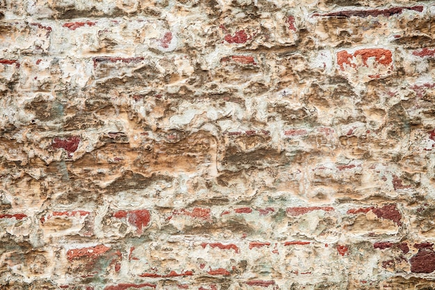 Cracked plaster on the brickwall, grunge of brown bricks