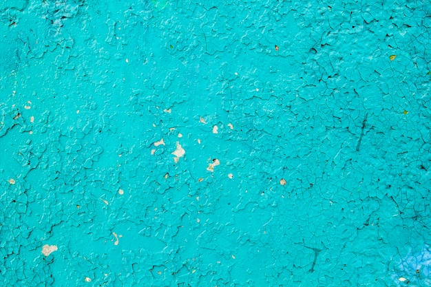 Cracked turquoise textured paint.