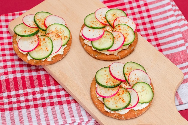 Cracker Sandwich with Cream Cheese Fresh Cucumber and Radish