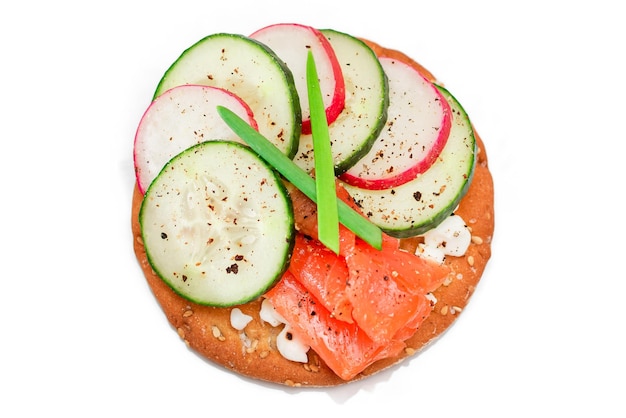 Cracker sandwich with salmon cucumber radish cottage cheese and green onions isolated