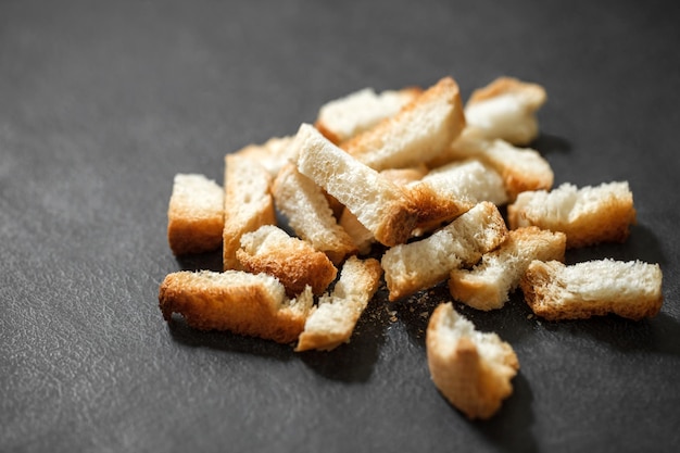 Crackers dried baked bread white bunch of broken on dark background selective focus