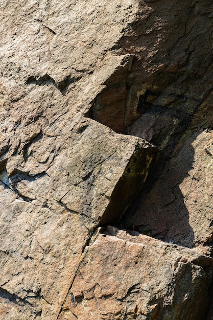 Cracks in the granite rock due to human activity. Destruction of the granite rock of the mountain after the explosion. Concept of environmental problems