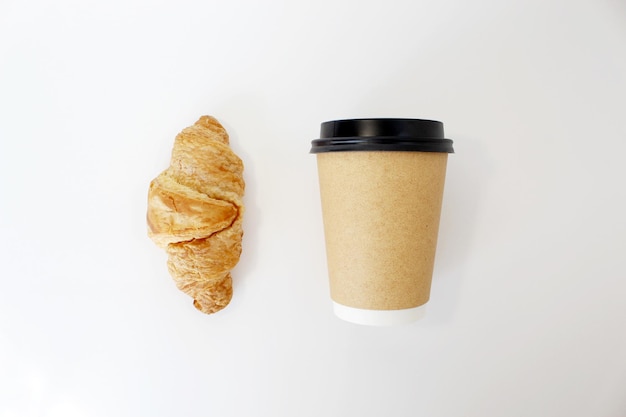 Craft coffee cup with croissant on white background