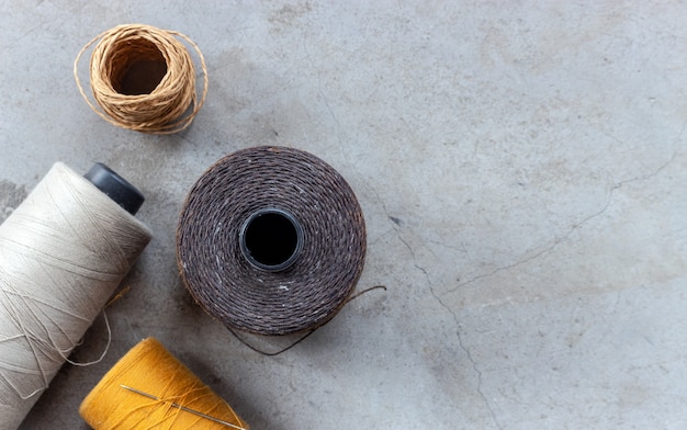 craft and DIY concept. sewing threads on cement floor. top view