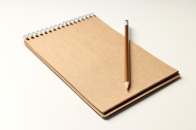 Craft notebook with pencil on white background