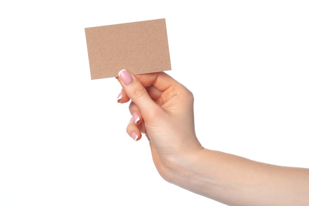 Craft paper card in female hand isolated on white