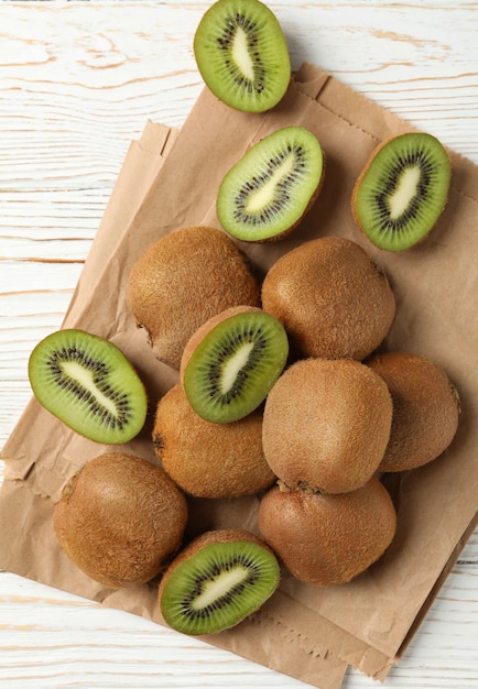 Craft paper with kiwi on wooden table