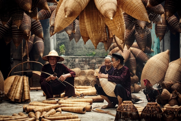 Craftsman making bamboo fish trap at old village, Hung Yen, Vietnam