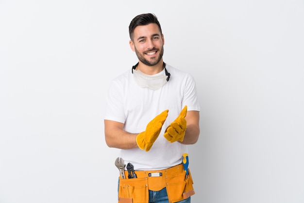 Craftsmen or electrician man over isolated white wall applauding