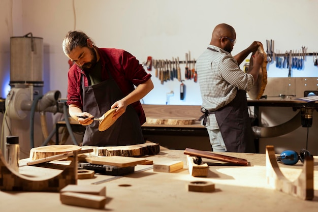 Craftsperson in studio applying paint on wood art piece enjoying hobby