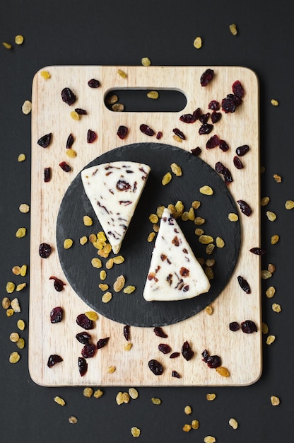 Cranberry cheese on a black slate board and wooden cutting board