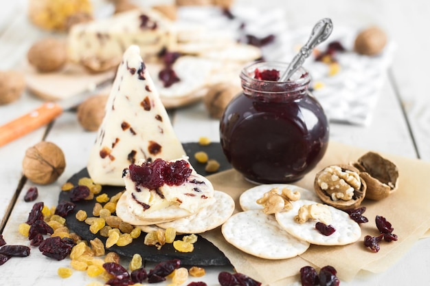 Cranberry cheese served with salty crackers jam walnut raisin and dried cranberry