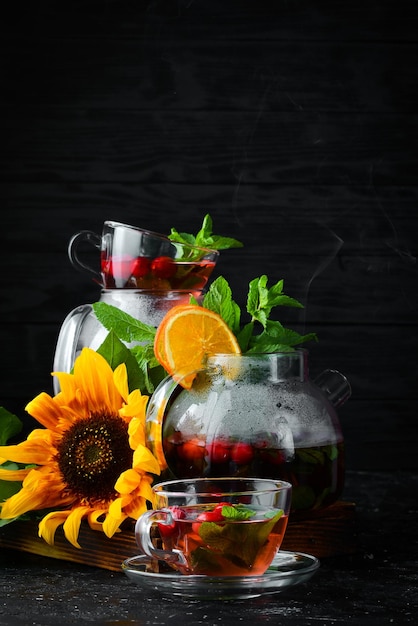 Cranberry and mint tea Hot winter drinks On a black background Top view