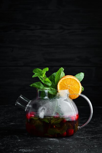 Cranberry and mint tea Hot winter drinks On a black background Top view