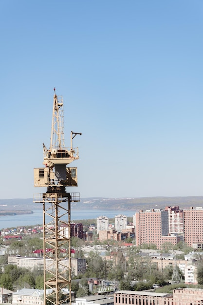 Crane at construction site panorama of city unfinished building building under construction panorama