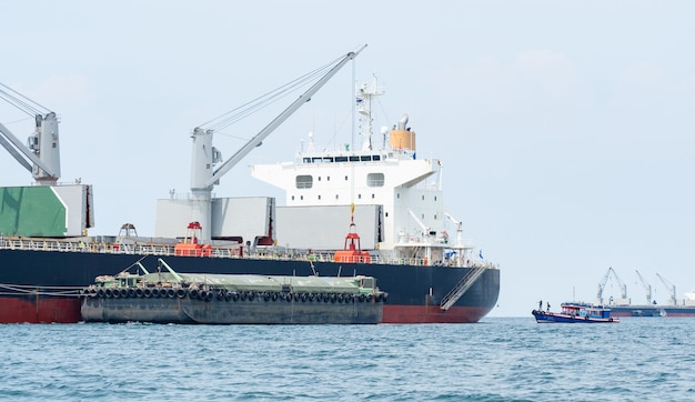 Crane in the industrial ship in ocean blue water and blue sky landscapeLogistic and transportation