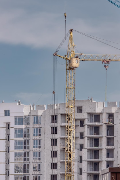 a crane is standing in front of a building with a building in the background