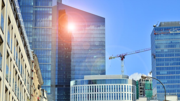 a crane is working on a building in the city