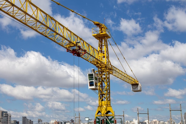 Crane on a job site in Sao Paulo, Brazil. With blue sky in the background