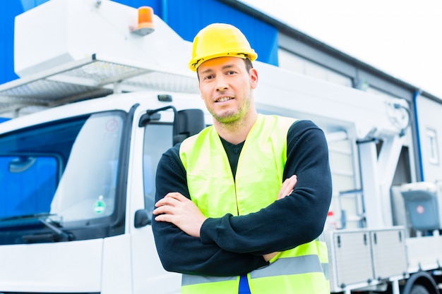 crane operator in front of truck on site