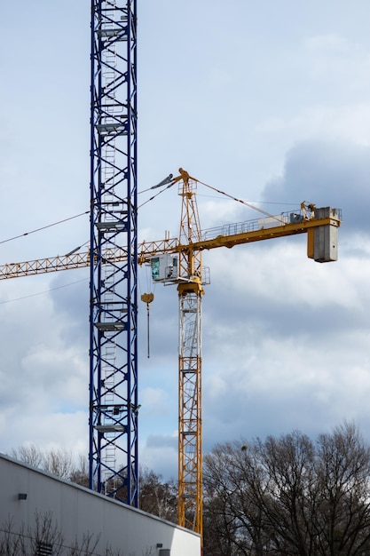 Cranes on the blue sky background building new buildings