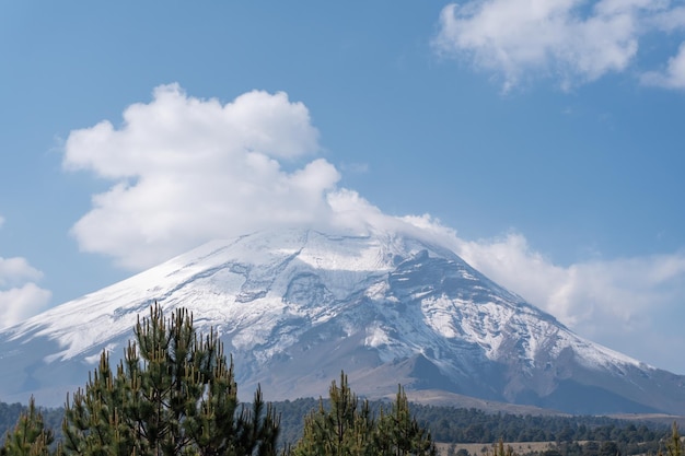 Crater between clouds of popocatepetl volcano in Mexico