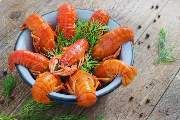 Crawfish in a bowl on wooden background