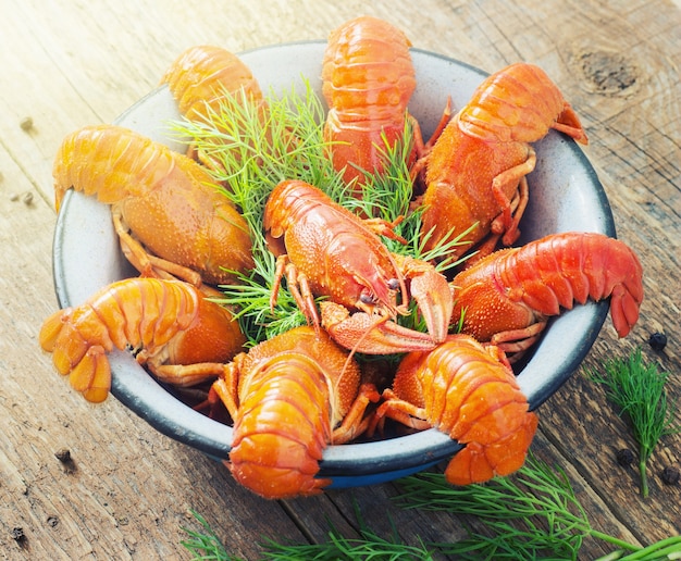 Crawfish in a bowl on wooden background