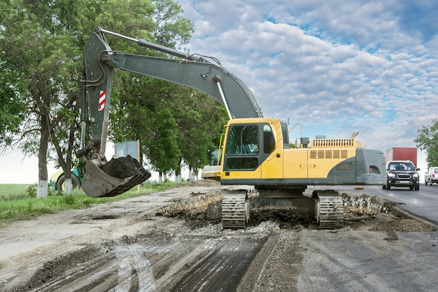 Crawler excavator repairs the road