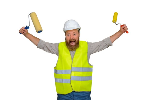 Crazy bearded man construction worker waving rollers and at the same time shouting something