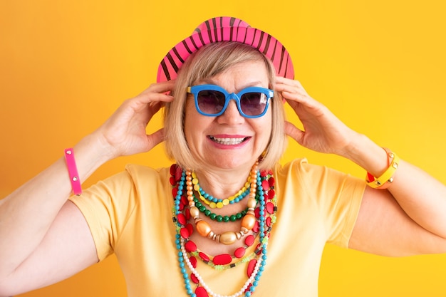 Crazy senior woman smile Happy smiling senior people on yellow background