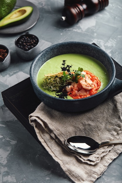 Cream of asparagus soup with shrimp. Green asparagus soup with tiger prawns