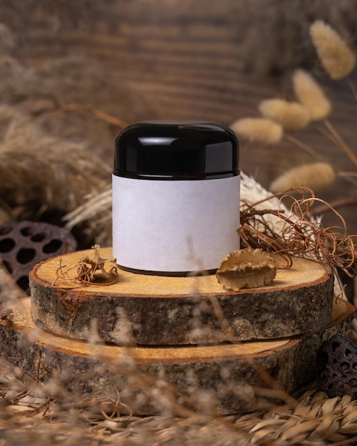 Cream jar with blank label on wood near natural decorations close up Packaging Mockup