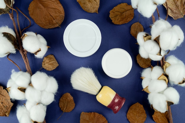 Cream jars, cotton and leaves. An indicator of the natural product.