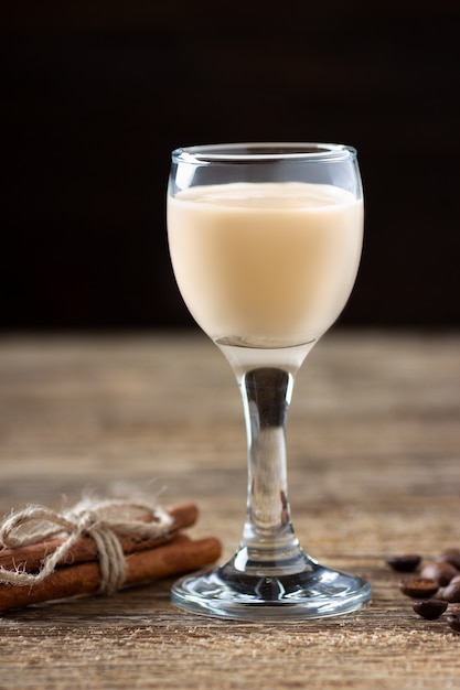 Cream liqueur on wooden table