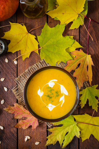 Cream of pumpkin soup with sour cream sauce. Halloween.