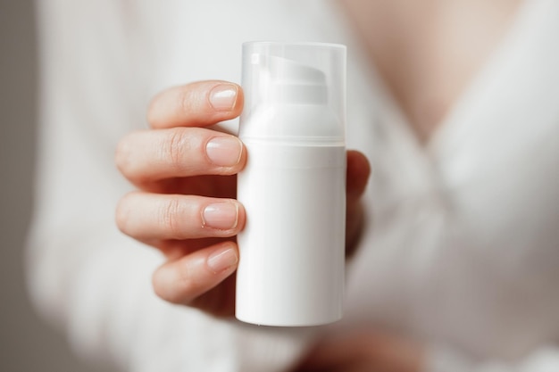 Cream skin care hands Closeup woman holding cream for hands Woman applying hand cream Girl holding tube with skin care produc in front of cameraView from frontSPF protectionSkin healthy