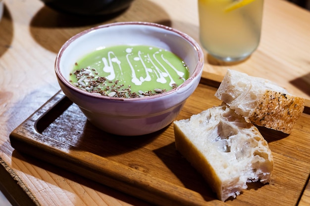 Cream soup of green peas with slices of bread vegetarian healthy food