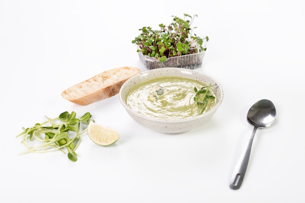 Cream soup with blue cheese, bread and microgreens