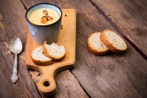 Photo cream soup with mussels in a cup