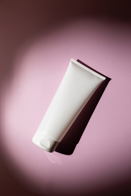 Cream tube on a pink background, mock up