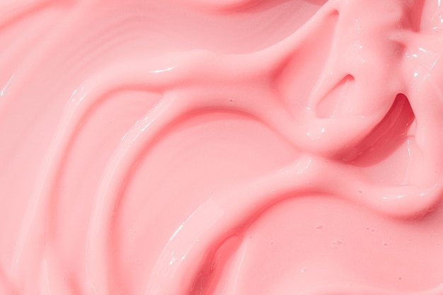 Creamy pink skincare lotion mousse product closeup peach cream moisturizer spread sunscreen cosmetic